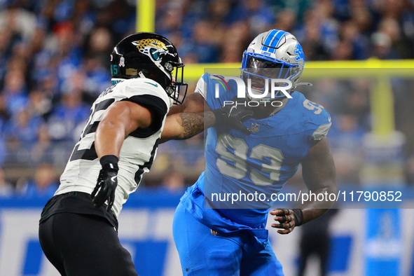 DETROIT,MICHIGAN-November 17: Jacksonville Jaguars tight end Brenton Strange (85) defends against Detroit Lions defensive end Josh Paschal (...