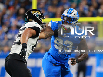 DETROIT,MICHIGAN-November 17: Jacksonville Jaguars tight end Brenton Strange (85) defends against Detroit Lions defensive end Josh Paschal (...