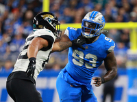 DETROIT,MICHIGAN-November 17: Jacksonville Jaguars tight end Brenton Strange (85) defends against Detroit Lions defensive end Josh Paschal (...