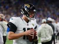 DETROIT,MICHIGAN-November 17: Jacksonville Jaguars quarterback Mac Jones (10) warms up during the first half of an NFL football game between...