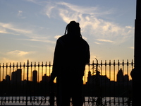 People take photos of the Jacqueline Kennedy Onassis Reservoir in Central Park while experiencing the fall weather in New York, N.Y., on Nov...