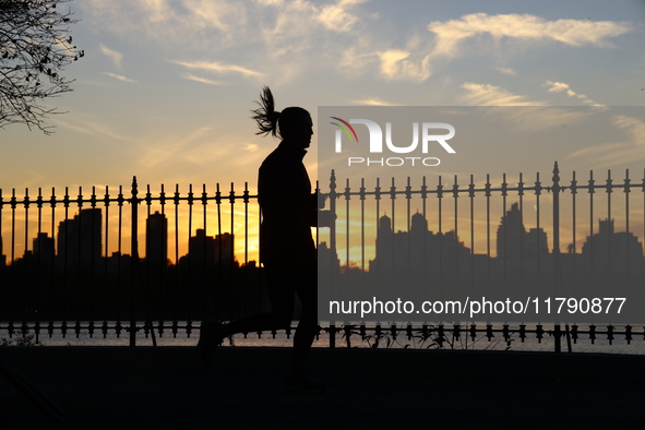 People jog around the Jacqueline Kennedy Onassis Reservoir in Central Park in New York, N.Y., on November 18, 2024, while experiencing the f...