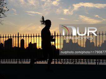 People jog around the Jacqueline Kennedy Onassis Reservoir in Central Park in New York, N.Y., on November 18, 2024, while experiencing the f...