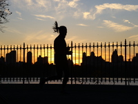 People jog around the Jacqueline Kennedy Onassis Reservoir in Central Park in New York, N.Y., on November 18, 2024, while experiencing the f...