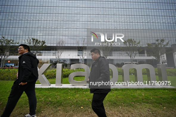 In Nanjing, China, on November 19, 2024, citizens walk past the East China headquarters building of Xiaomi Group. Xiaomi Group announces tha...