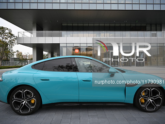 A Xiaomi car is seen at the entrance of the East China headquarters building of Xiaomi Group in Nanjing, China, on November 19, 2024. Xiaomi...