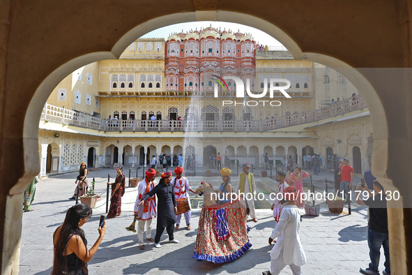 Tourists dance with Rajasthani folk artists at the historical Hawa Mahal on the occasion of the 297th Foundation of 'Pinkcity' in Jaipur, Ra...