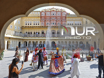 Tourists dance with Rajasthani folk artists at the historical Hawa Mahal on the occasion of the 297th Foundation of 'Pinkcity' in Jaipur, Ra...