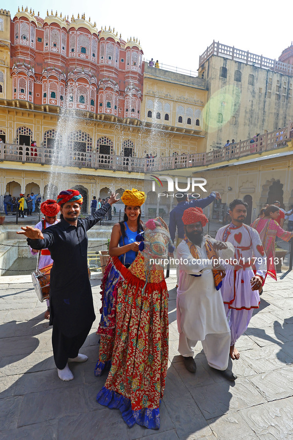 Tourists dance with Rajasthani folk artists at the historical Hawa Mahal on the occasion of the 297th Foundation of 'Pinkcity' in Jaipur, Ra...