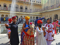 Tourists dance with Rajasthani folk artists at the historical Hawa Mahal on the occasion of the 297th Foundation of 'Pinkcity' in Jaipur, Ra...