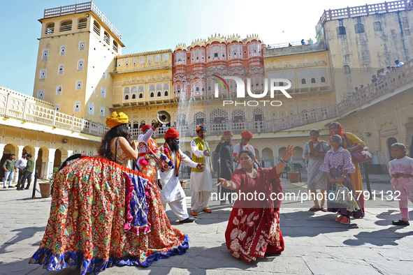 Tourists dance with Rajasthani folk artists at the historical Hawa Mahal on the occasion of the 297th Foundation of 'Pinkcity' in Jaipur, Ra...