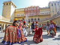 Tourists dance with Rajasthani folk artists at the historical Hawa Mahal on the occasion of the 297th Foundation of 'Pinkcity' in Jaipur, Ra...