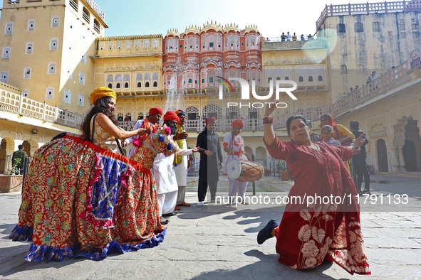 Tourists dance with Rajasthani folk artists at the historical Hawa Mahal on the occasion of the 297th Foundation of 'Pinkcity' in Jaipur, Ra...