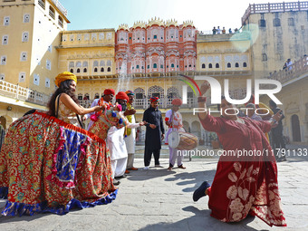 Tourists dance with Rajasthani folk artists at the historical Hawa Mahal on the occasion of the 297th Foundation of 'Pinkcity' in Jaipur, Ra...