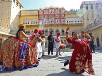 Tourists dance with Rajasthani folk artists at the historical Hawa Mahal on the occasion of the 297th Foundation of 'Pinkcity' in Jaipur, Ra...