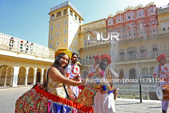 Tourists dance with Rajasthani folk artists at the historical Hawa Mahal on the occasion of the 297th Foundation of 'Pinkcity' in Jaipur, Ra...