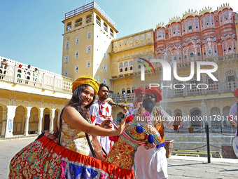 Tourists dance with Rajasthani folk artists at the historical Hawa Mahal on the occasion of the 297th Foundation of 'Pinkcity' in Jaipur, Ra...