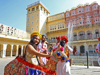 Tourists dance with Rajasthani folk artists at the historical Hawa Mahal on the occasion of the 297th Foundation of 'Pinkcity' in Jaipur, Ra...