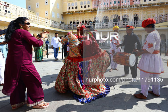 Tourists dance with Rajasthani folk artists at the historical Hawa Mahal on the occasion of the 297th Foundation of 'Pinkcity' in Jaipur, Ra...