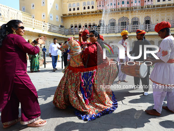 Tourists dance with Rajasthani folk artists at the historical Hawa Mahal on the occasion of the 297th Foundation of 'Pinkcity' in Jaipur, Ra...