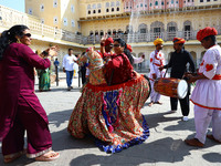 Tourists dance with Rajasthani folk artists at the historical Hawa Mahal on the occasion of the 297th Foundation of 'Pinkcity' in Jaipur, Ra...