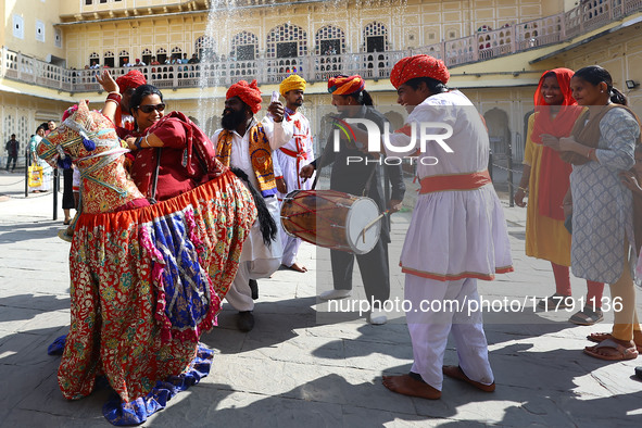 Tourists dance with Rajasthani folk artists at the historical Hawa Mahal on the occasion of the 297th Foundation of 'Pinkcity' in Jaipur, Ra...