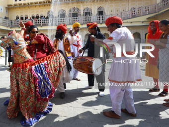 Tourists dance with Rajasthani folk artists at the historical Hawa Mahal on the occasion of the 297th Foundation of 'Pinkcity' in Jaipur, Ra...