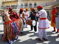 Tourists dance with Rajasthani folk artists at the historical Hawa Mahal on the occasion of the 297th Foundation of 'Pinkcity' in Jaipur, Ra...