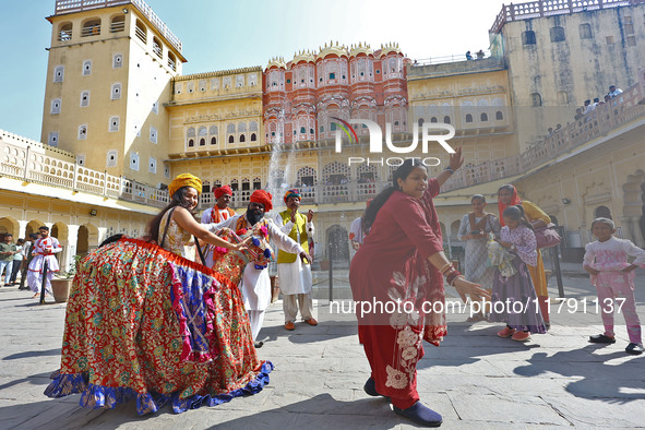 Tourists dance with Rajasthani folk artists at the historical Hawa Mahal on the occasion of the 297th Foundation of 'Pinkcity' in Jaipur, Ra...