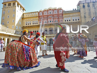 Tourists dance with Rajasthani folk artists at the historical Hawa Mahal on the occasion of the 297th Foundation of 'Pinkcity' in Jaipur, Ra...