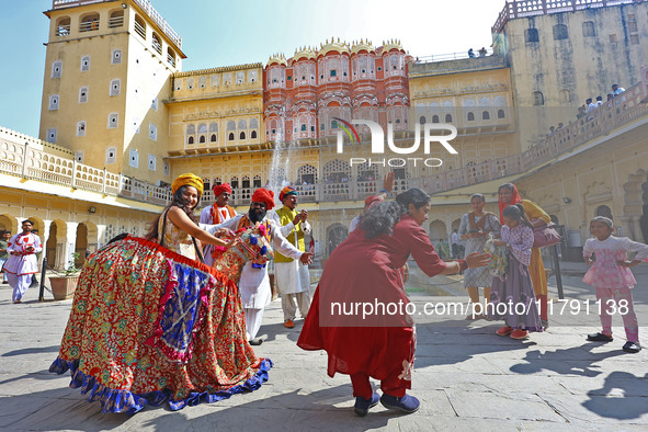 Tourists dance with Rajasthani folk artists at the historical Hawa Mahal on the occasion of the 297th Foundation of 'Pinkcity' in Jaipur, Ra...