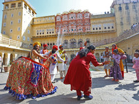 Tourists dance with Rajasthani folk artists at the historical Hawa Mahal on the occasion of the 297th Foundation of 'Pinkcity' in Jaipur, Ra...