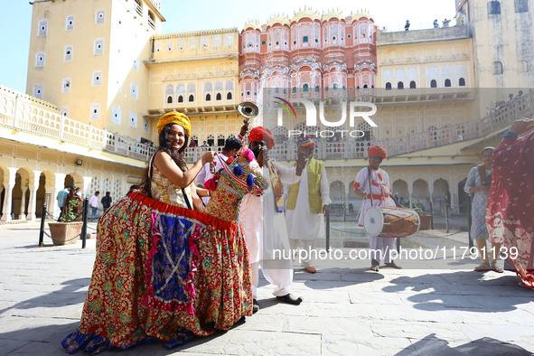 Tourists dance with Rajasthani folk artists at the historical Hawa Mahal on the occasion of the 297th Foundation of 'Pinkcity' in Jaipur, Ra...