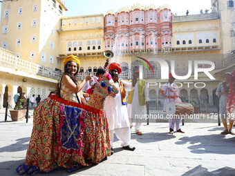 Tourists dance with Rajasthani folk artists at the historical Hawa Mahal on the occasion of the 297th Foundation of 'Pinkcity' in Jaipur, Ra...