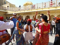 Tourists dance with Rajasthani folk artists at the historical Hawa Mahal on the occasion of the 297th Foundation of 'Pinkcity' in Jaipur, Ra...