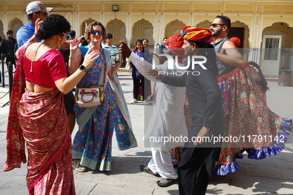 Tourists dance with Rajasthani folk artists at the historical Hawa Mahal on the occasion of the 297th Foundation of 'Pinkcity' in Jaipur, Ra...