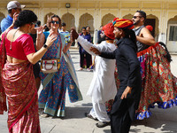 Tourists dance with Rajasthani folk artists at the historical Hawa Mahal on the occasion of the 297th Foundation of 'Pinkcity' in Jaipur, Ra...