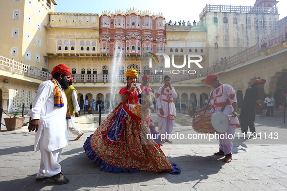 Tourists dance with Rajasthani folk artists at the historical Hawa Mahal on the occasion of the 297th Foundation of 'Pinkcity' in Jaipur, Ra...