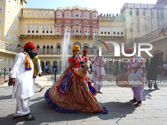 Tourists dance with Rajasthani folk artists at the historical Hawa Mahal on the occasion of the 297th Foundation of 'Pinkcity' in Jaipur, Ra...