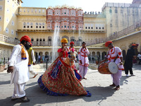 Tourists dance with Rajasthani folk artists at the historical Hawa Mahal on the occasion of the 297th Foundation of 'Pinkcity' in Jaipur, Ra...