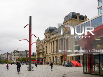 This scene shows people navigating the vibrant square outside the Opera Metro Station in Antwerp, Belgium, on July 31, 2023. Pedestrians and...