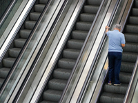 A man ascends the escalator inside the Antwerp Opera Metro Station in Antwerp, Belgium, on July 31, 2023. The scene captures the rhythm of d...