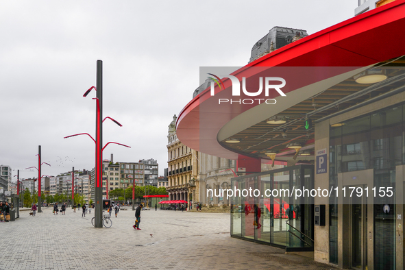 This scene shows people navigating the vibrant square outside the Opera Metro Station in Antwerp, Belgium, on July 31, 2023. Pedestrians mov...