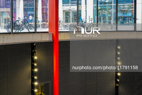 The interior lighting design of Antwerp's Opera Metro Station in Antwerp, Belgium, on July 31, 2023, features a bright, sleek red support be...