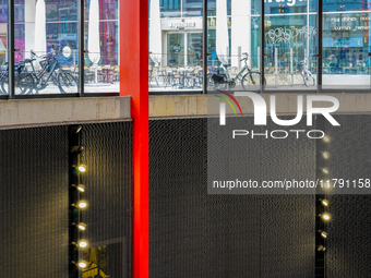 The interior lighting design of Antwerp's Opera Metro Station in Antwerp, Belgium, on July 31, 2023, features a bright, sleek red support be...