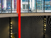 The interior lighting design of Antwerp's Opera Metro Station in Antwerp, Belgium, on July 31, 2023, features a bright, sleek red support be...