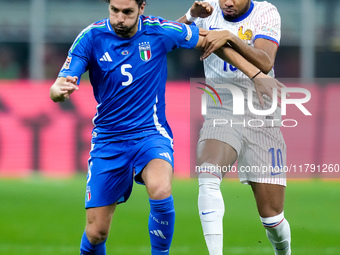 Manuel Locatelli of Italy and Christopher Nkunku of France compete for the ball during the UEFA Nations League 2024/25 League A Group 2 matc...