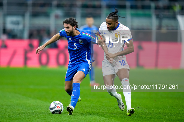 Christopher Nkunku of France and Manuel Locatelli of Italy compete for the ball during the UEFA Nations League 2024/25 League A Group 2 matc...