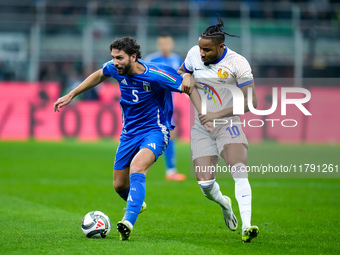 Christopher Nkunku of France and Manuel Locatelli of Italy compete for the ball during the UEFA Nations League 2024/25 League A Group 2 matc...