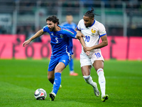 Christopher Nkunku of France and Manuel Locatelli of Italy compete for the ball during the UEFA Nations League 2024/25 League A Group 2 matc...